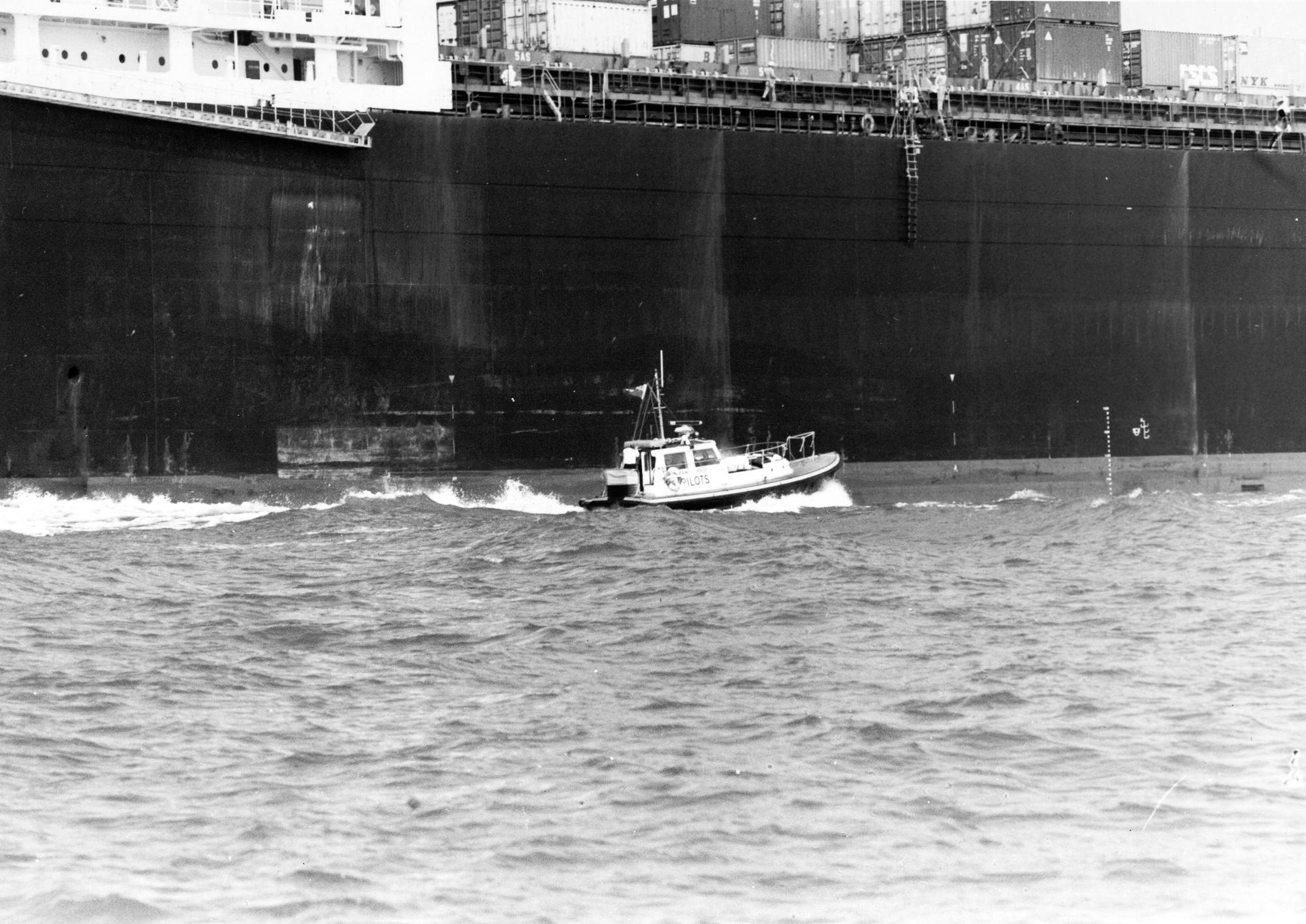 Pilot boat approaches cargo ship