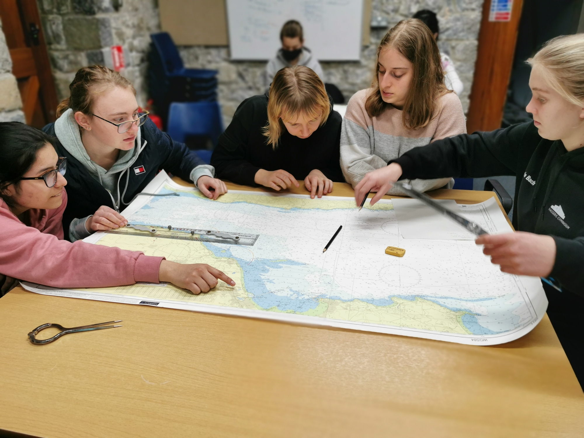 UWC Atlantic students looking at a nautical chart